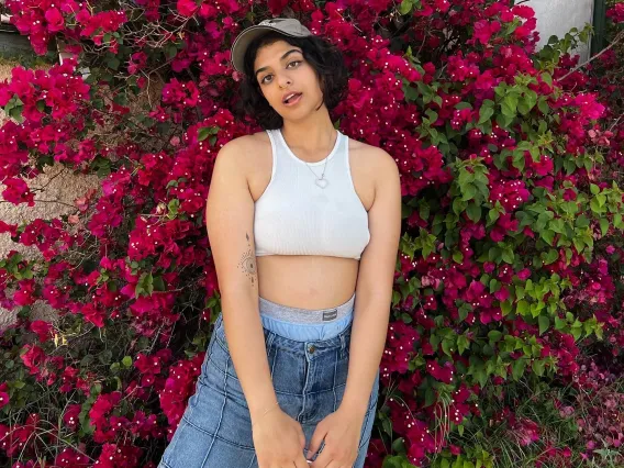 Nousha standing in front of a hot pink bougainvillea